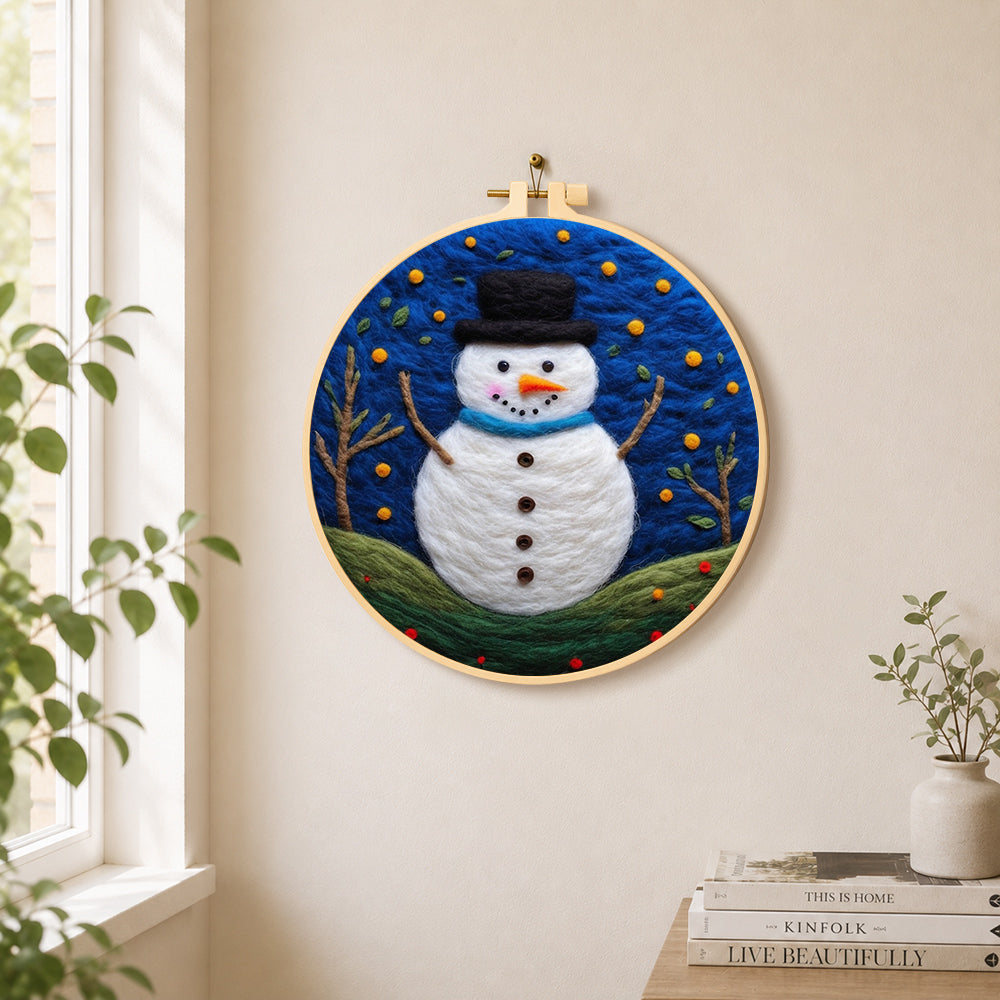Snowman under the starry blue night needle felt wall art displayed in a bright home interior