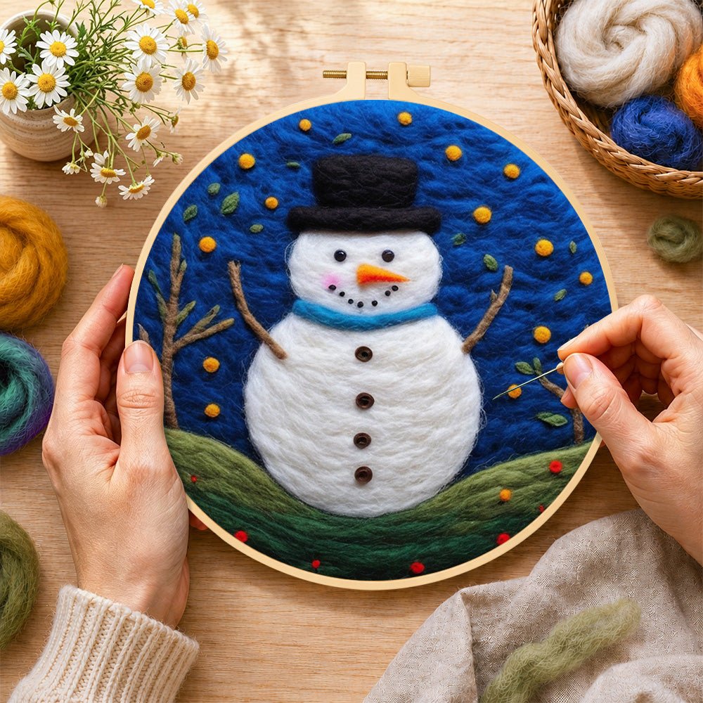 Creating the snowman under the starry blue night wool painting by hand with a felting needle