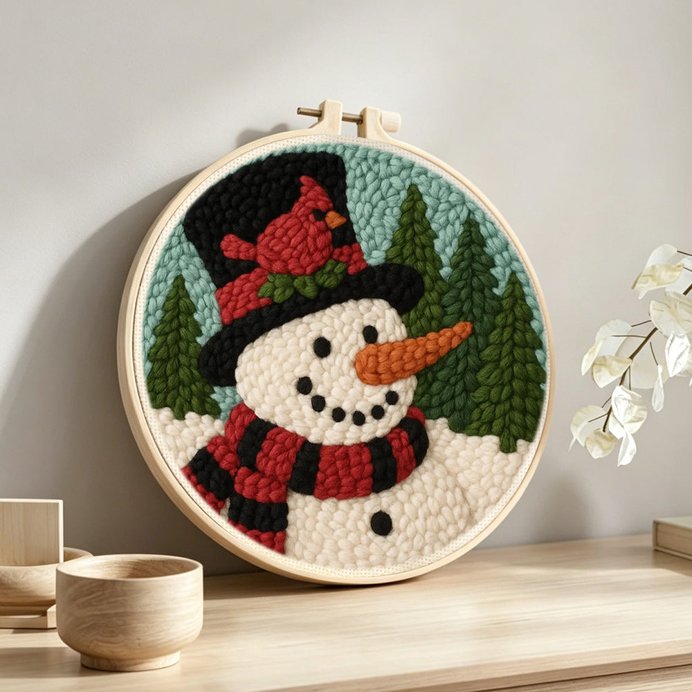 Snowman with red cardinal bird punch needle artwork displayed on a table