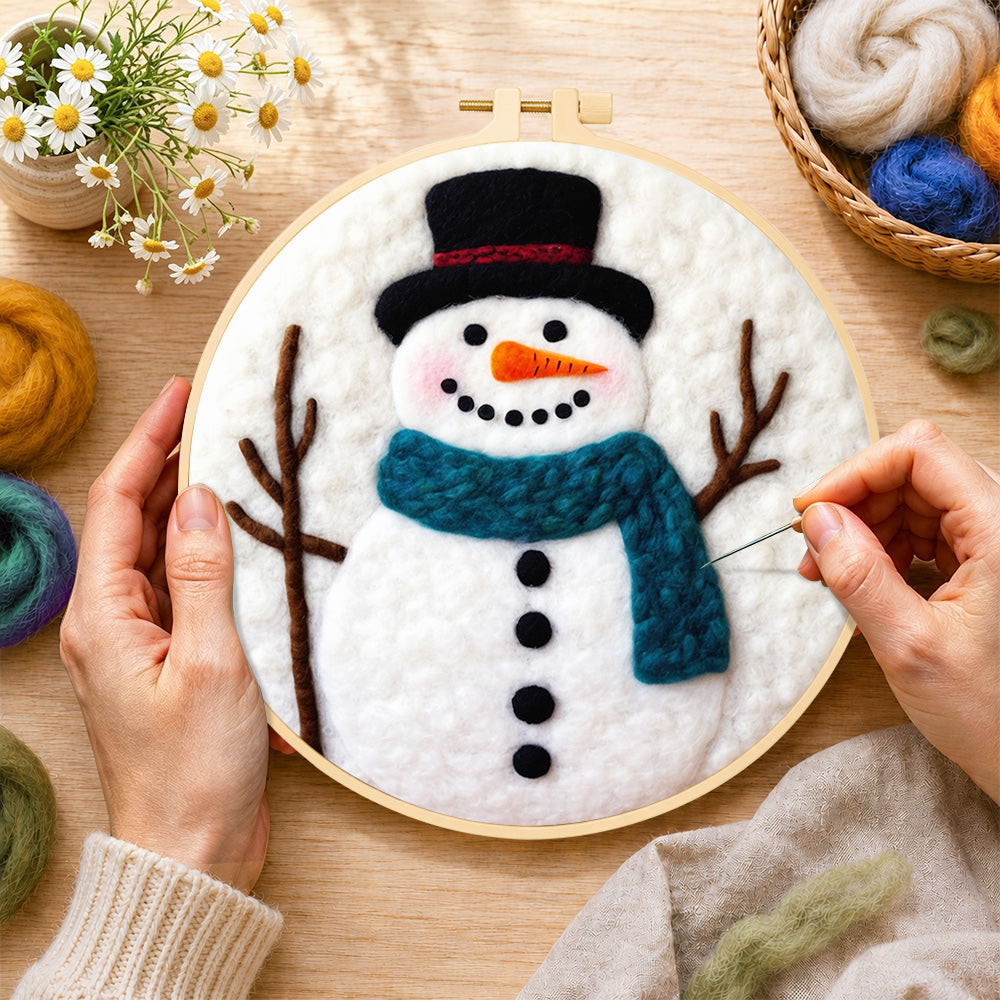 Creating the snowman with teal scarf wool painting by hand with a felting needle