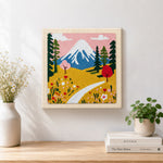 Finished snowy mountain and wildflowers artwork displayed on a wall