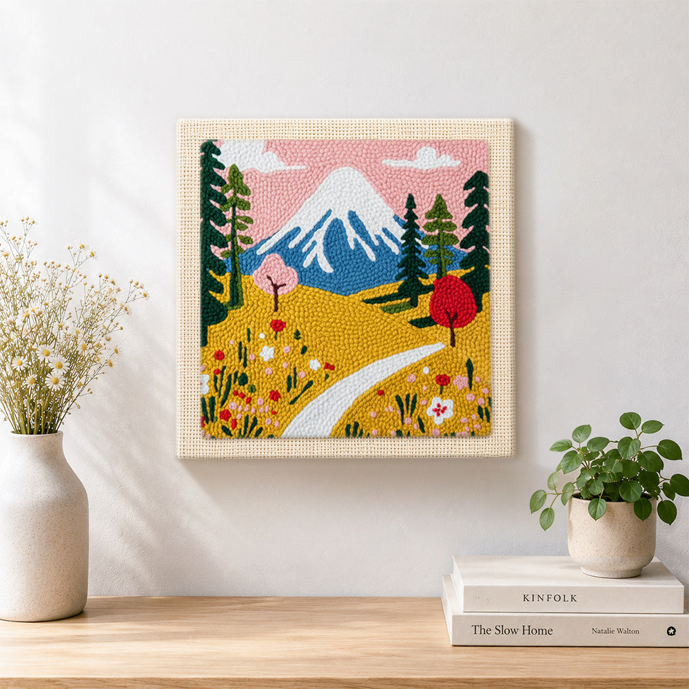 Finished snowy mountain and wildflowers artwork displayed on a wall