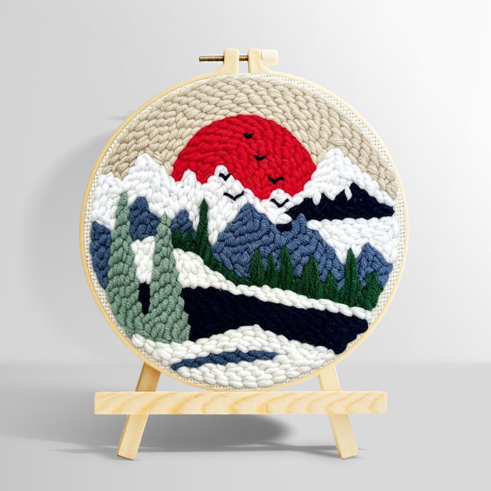 Snowy mountain landscape with pine trees and red sun punch needle kit for beginners
