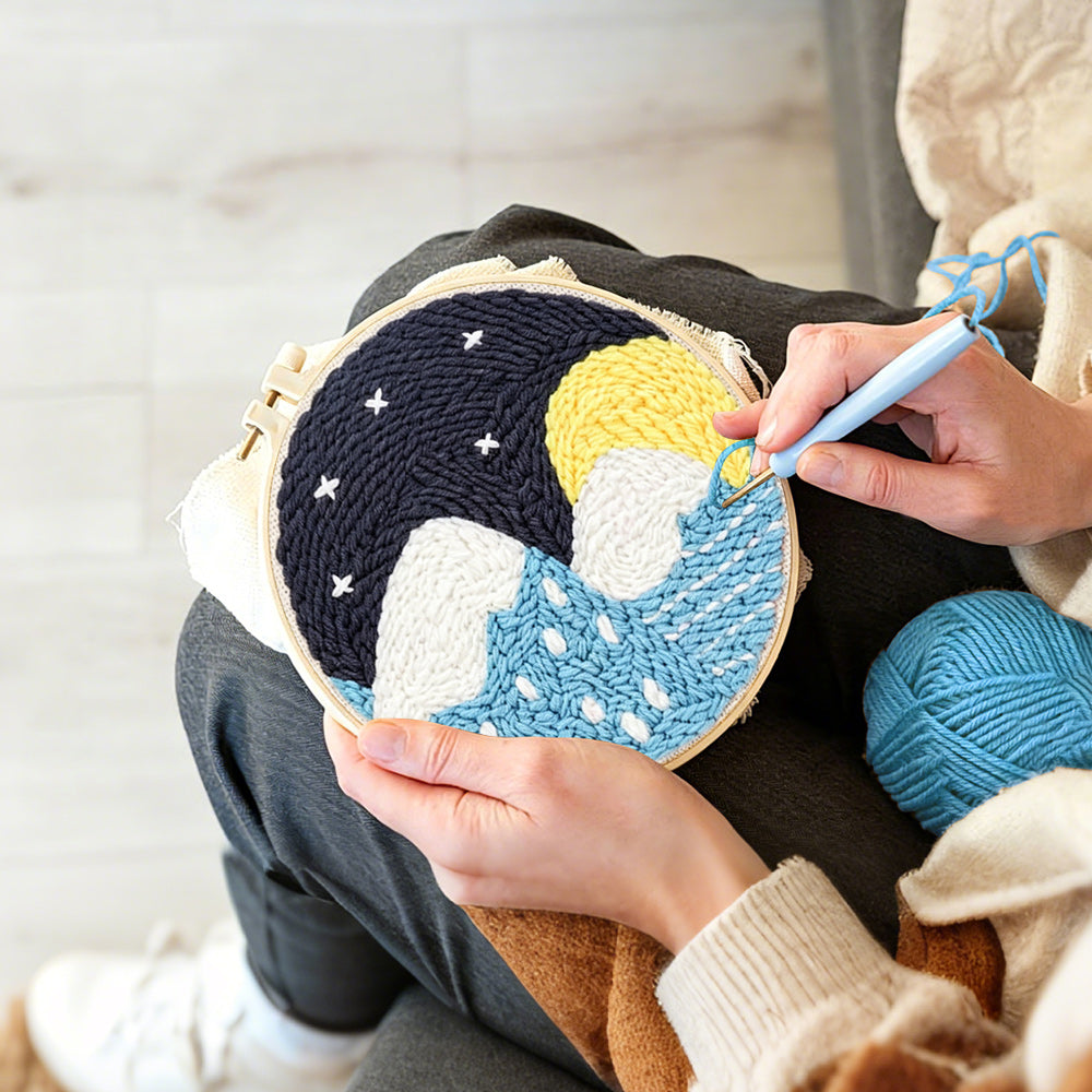 Creating handmade snowy mountains and blue water under starry sky punch needle artwork