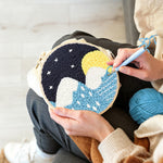 Creating handmade snowy mountains and blue water under starry sky punch needle artwork