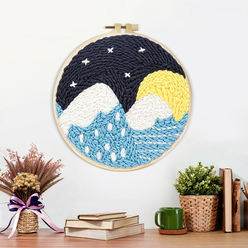 Finished snowy mountains and blue water under starry sky artwork displayed on a wall