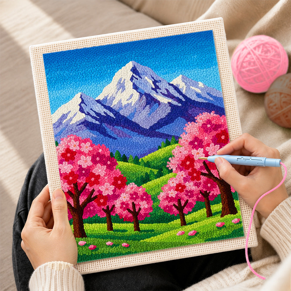 Creating handmade snowy peaks and pink sakura trees punch needle artwork