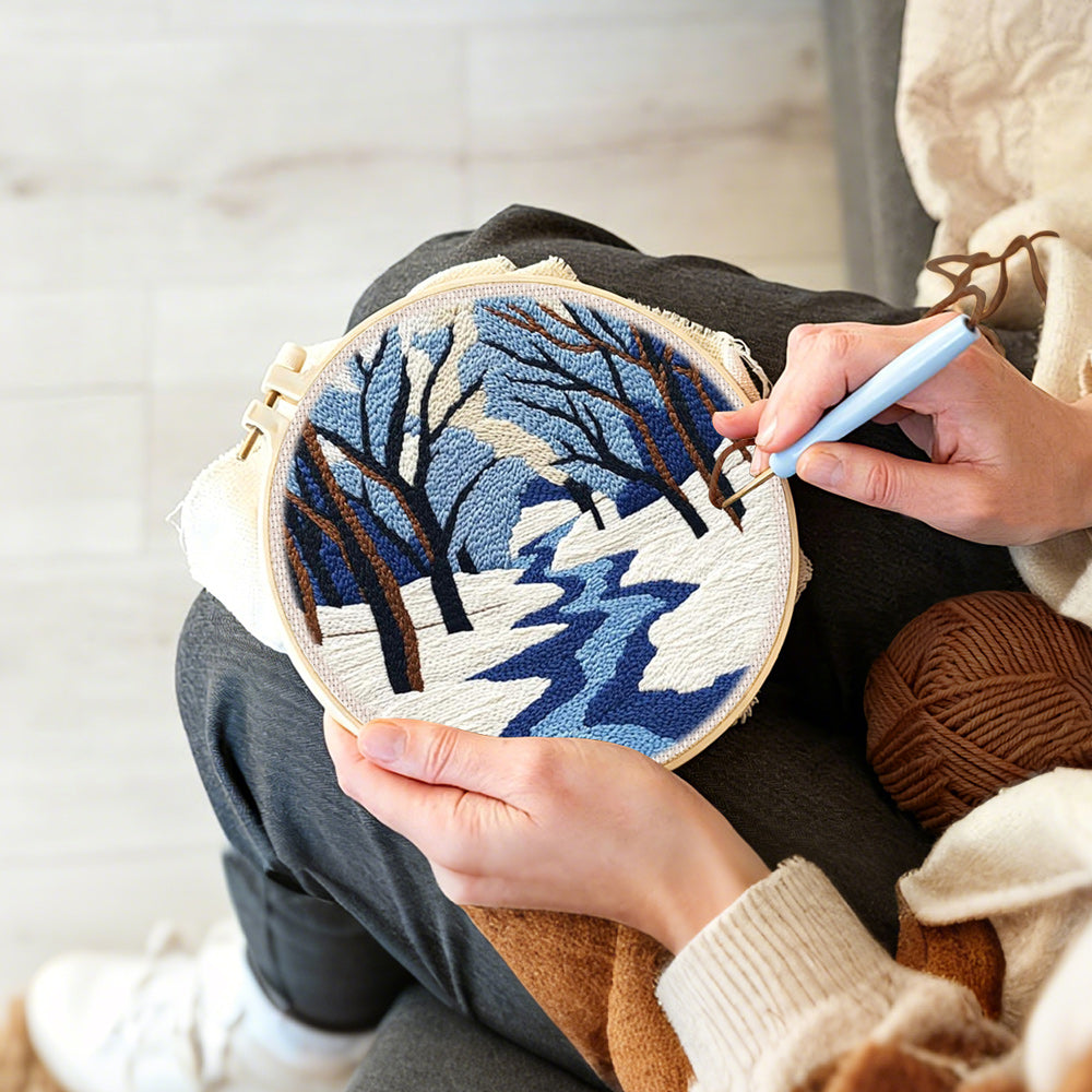Creating handmade snowy river landscape with bare trees punch needle artwork