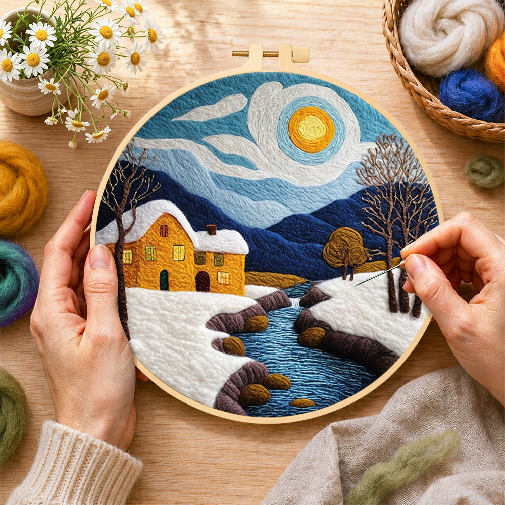 Creating the snowy stream and yellow cottage wool painting by hand with a felting needle