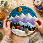 Creating the snowy village under the mountains wool painting by hand with a felting needle