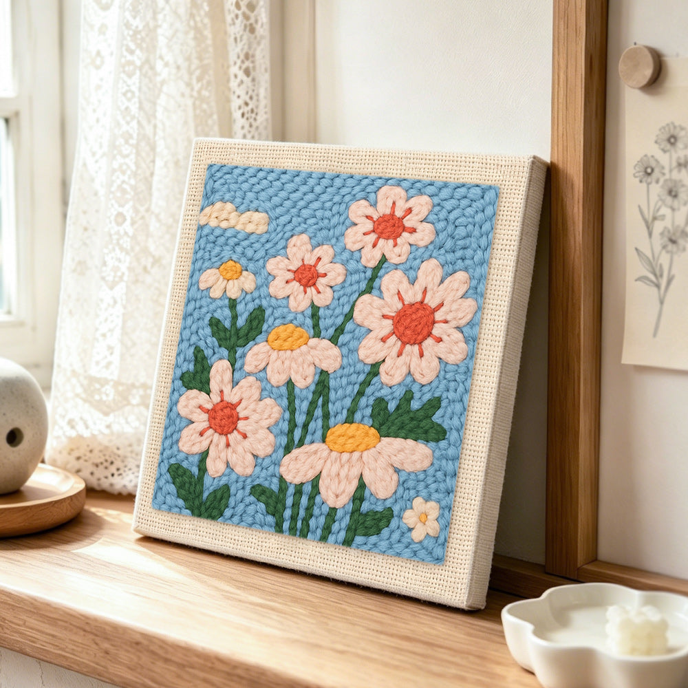 Soft daisies punch needle artwork displayed on a table