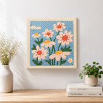 Finished soft daisies artwork displayed on a wall