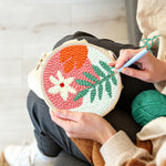 Creating handmade soft green and orange botanical punch needle artwork