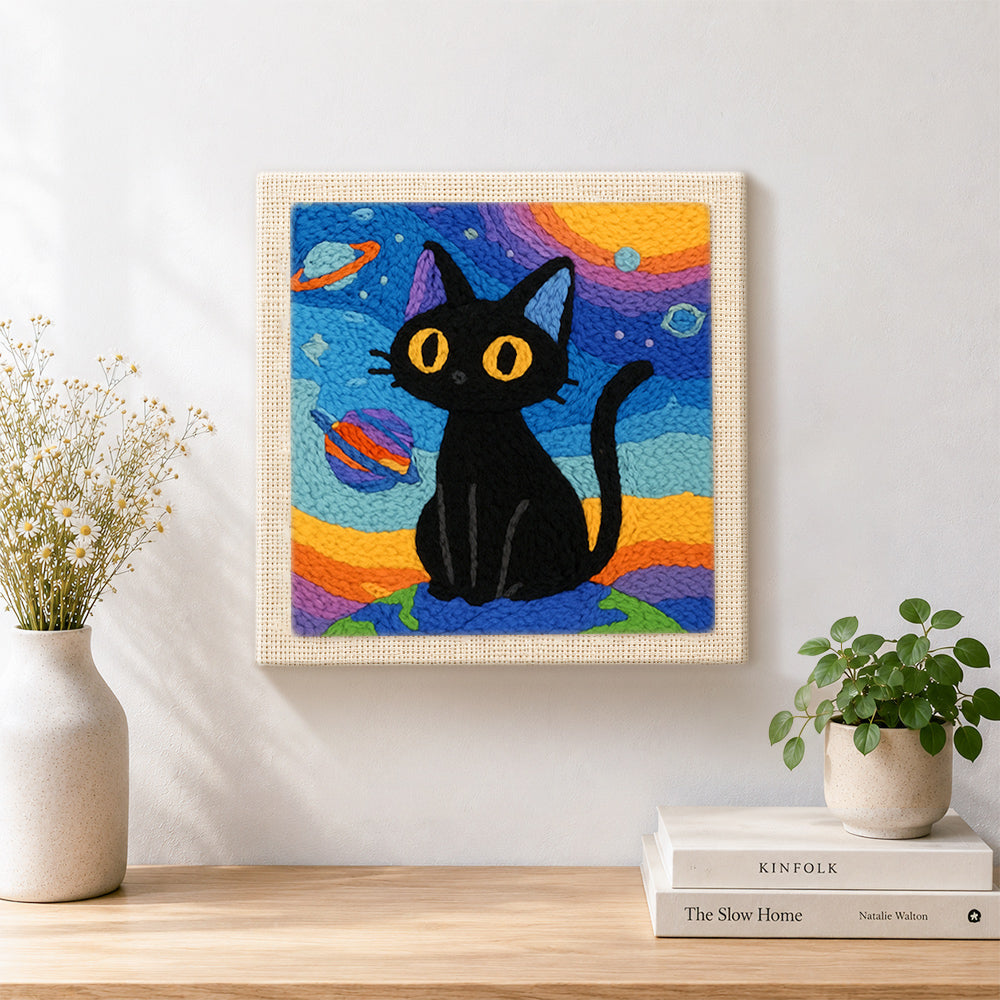 Finished space black cat with yellow eyes artwork displayed on a wall