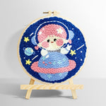 Space girl sitting on a planet punch needle kit for beginners