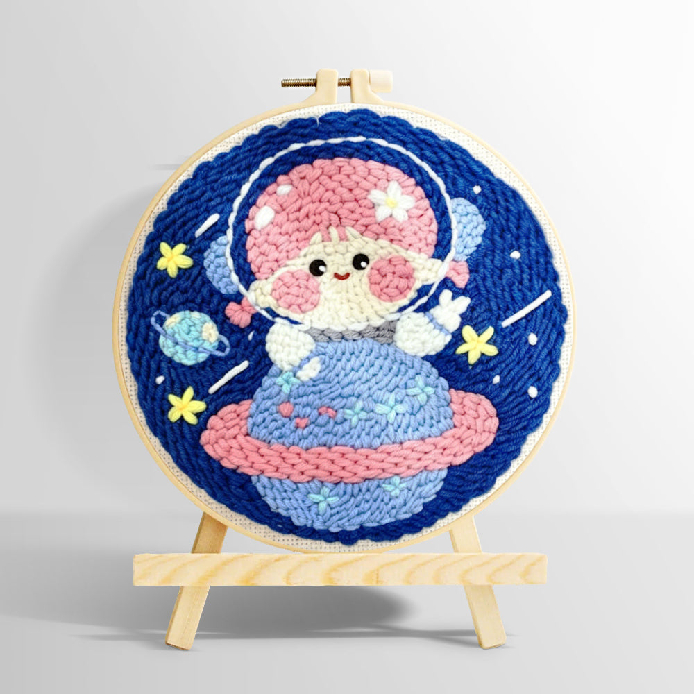 Space girl sitting on a planet punch needle kit for beginners