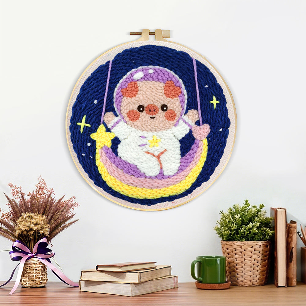 Finished space piggy on rainbow swing artwork displayed on a wall
