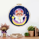Finished space piggy on rainbow swing artwork displayed on a wall