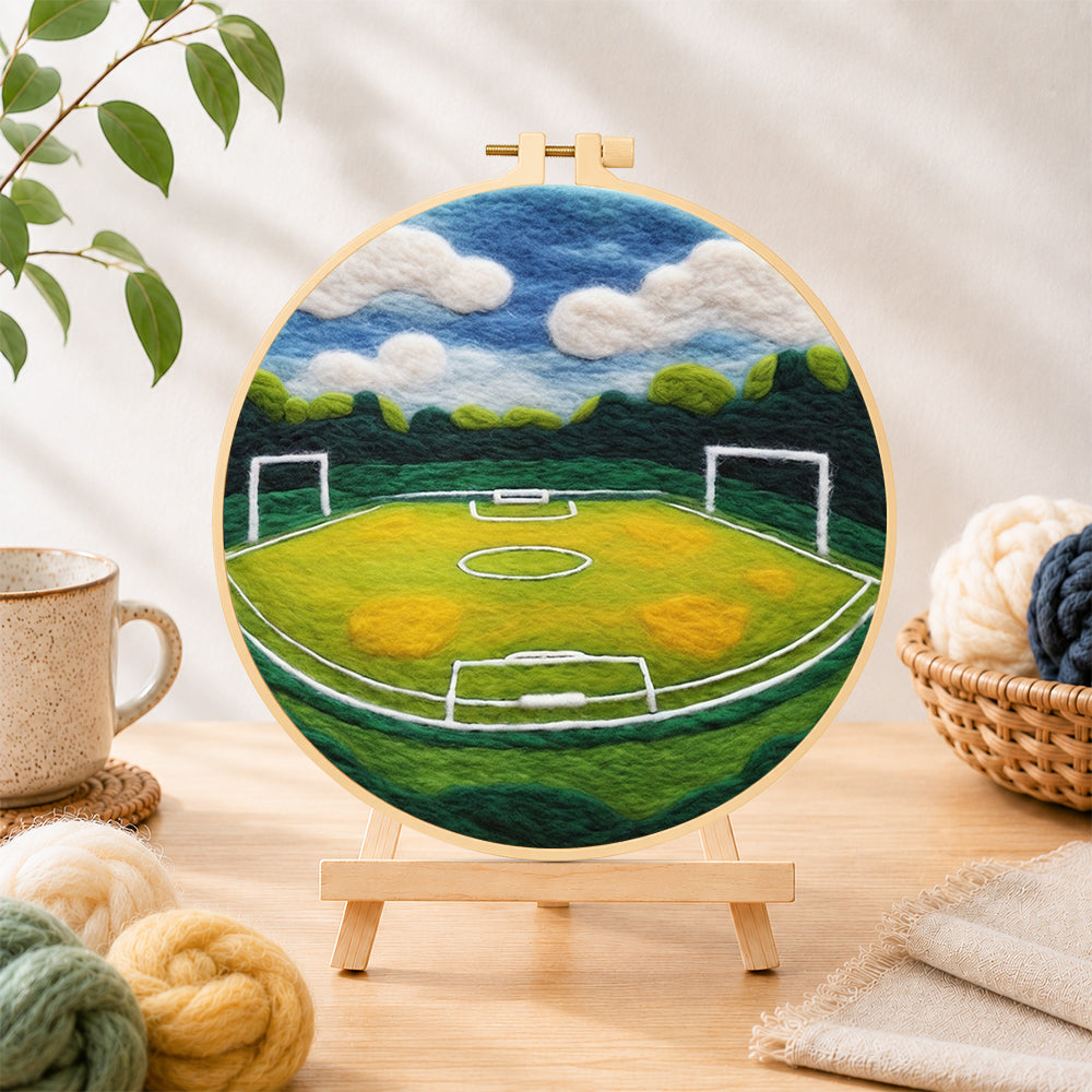 Finished spacious football pitch needle felting displayed on a wooden easel
