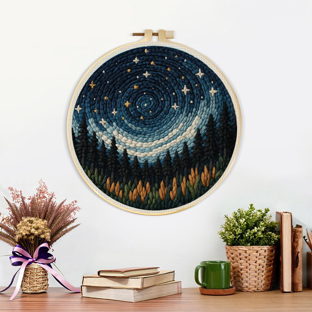 Finished spiral blue starry sky and black forest artwork displayed on a wall