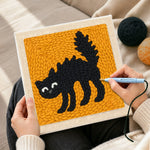 Creating handmade spoof scaredy cat punch needle artwork