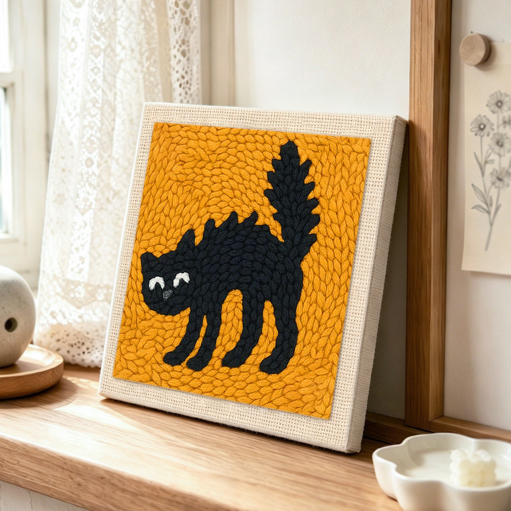 Spoof scaredy cat punch needle artwork displayed on a table