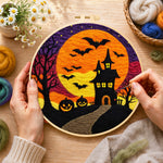 Creating the spooky orange moon and bat castle wool painting by hand with a felting needle