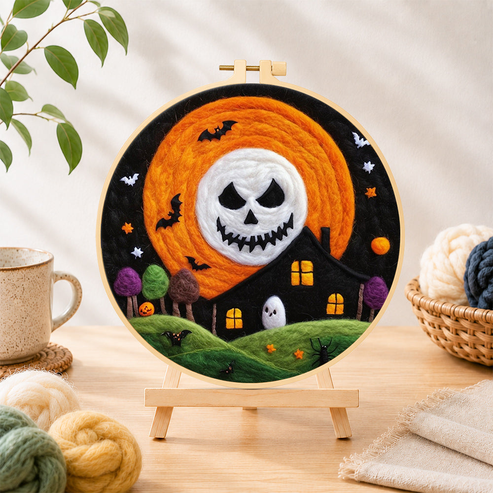 Finished spooky skeleton face moon needle felting displayed on a wooden easel