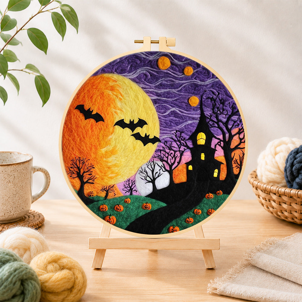 Finished spooky yellow moon and bare trees needle felting displayed on a wooden easel