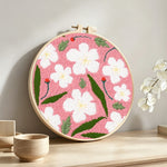 Spring blossom punch needle artwork displayed on a table