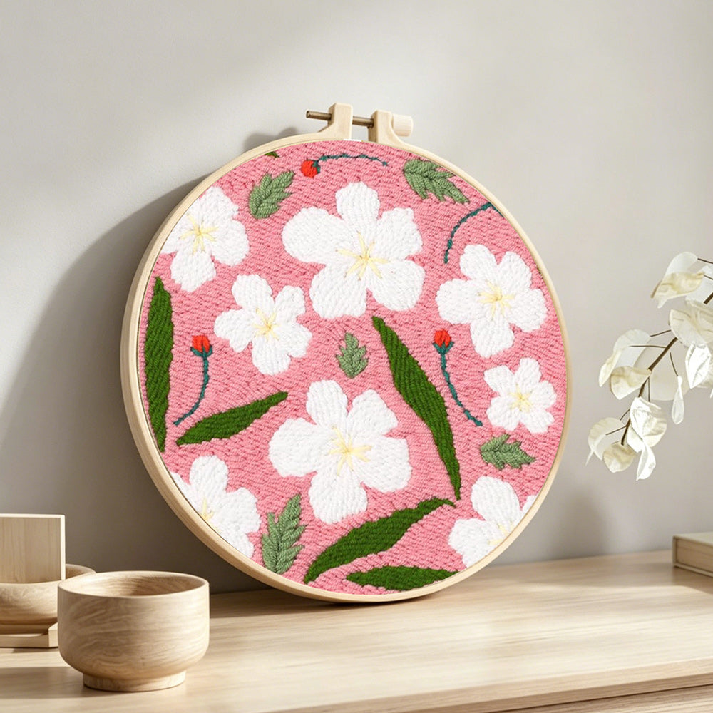 Spring blossom punch needle artwork displayed on a table
