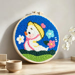 Spring duckling punch needle artwork displayed on a table