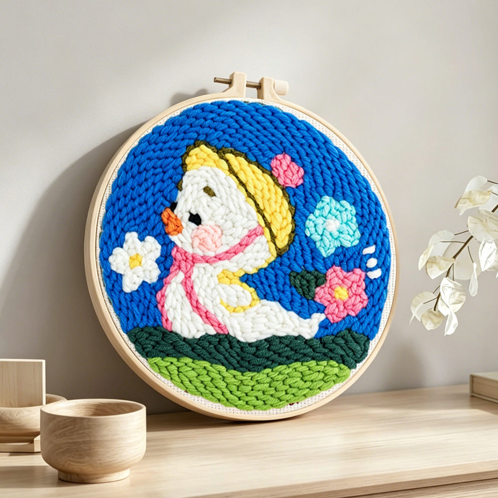 Spring duckling punch needle artwork displayed on a table
