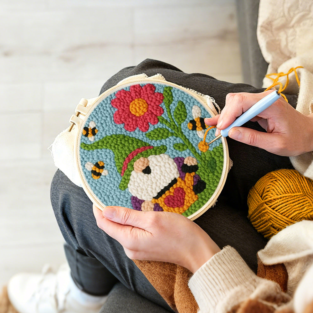 Creating handmade spring gnome with flower and bees punch needle artwork