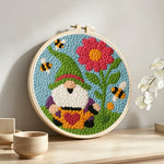 Spring gnome with flower and bees punch needle artwork displayed on a table