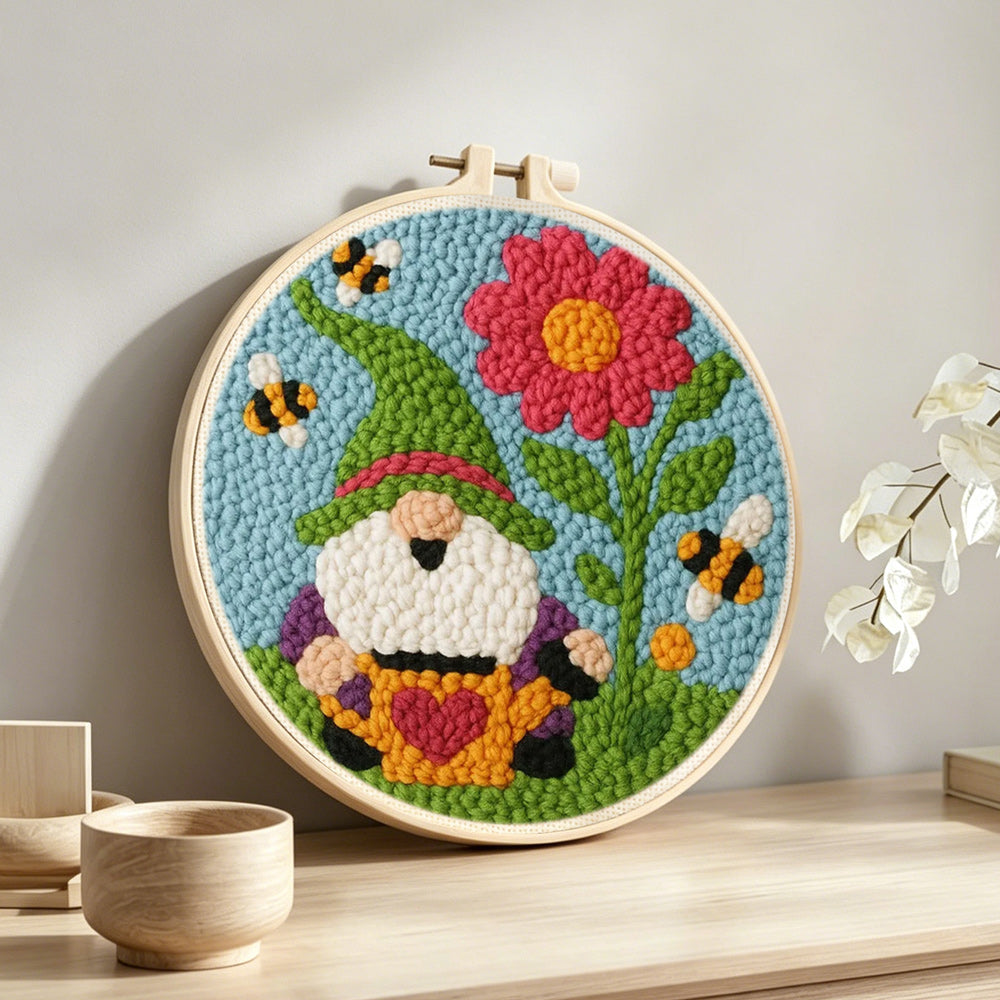Spring gnome with flower and bees punch needle artwork displayed on a table