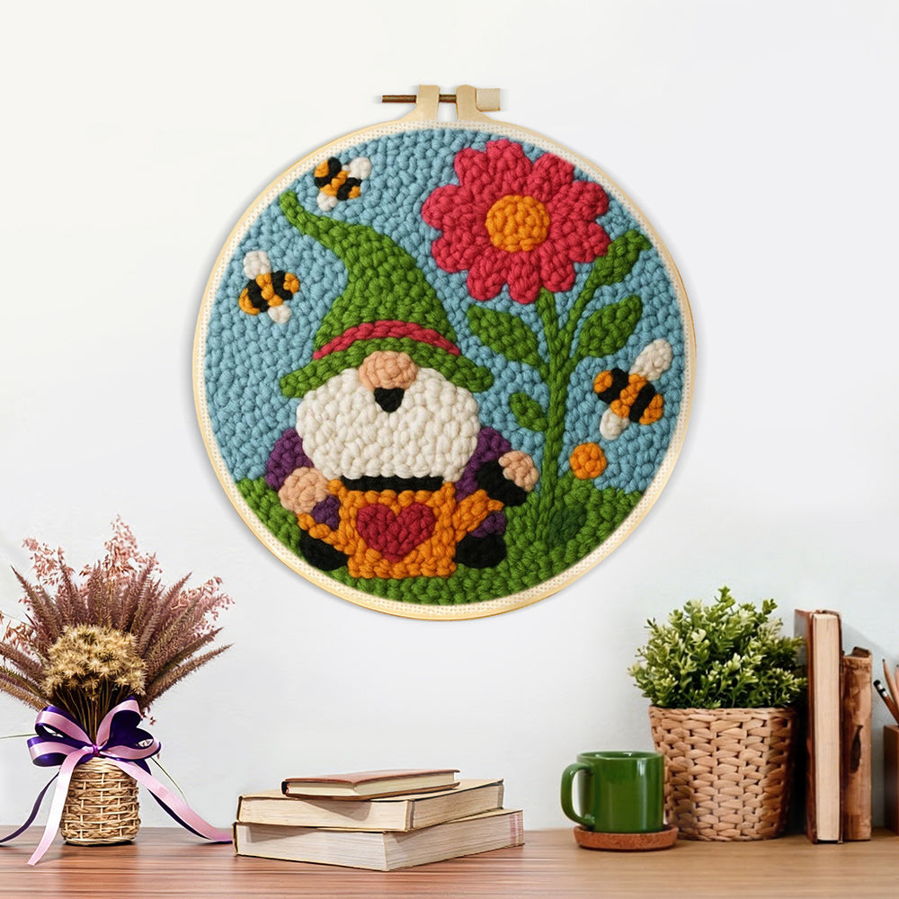 Finished spring gnome with flower and bees artwork displayed on a wall