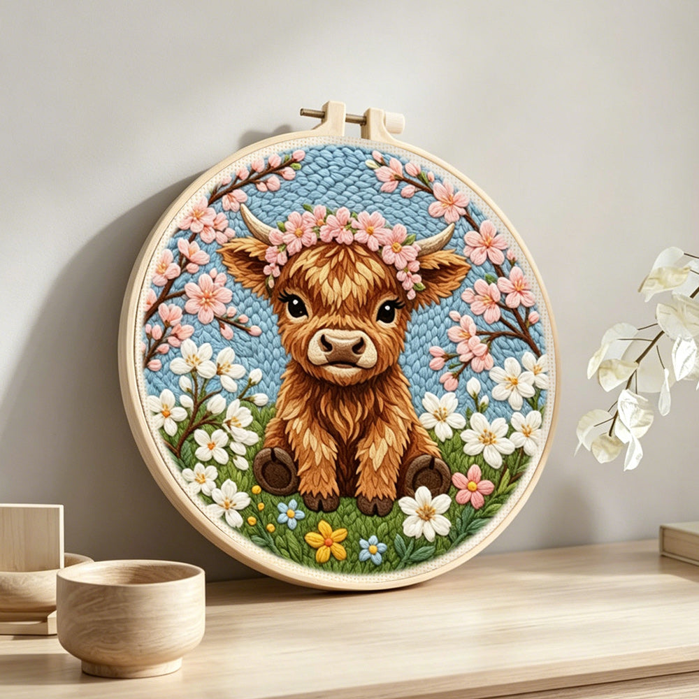 Spring highland cow punch needle artwork displayed on a table