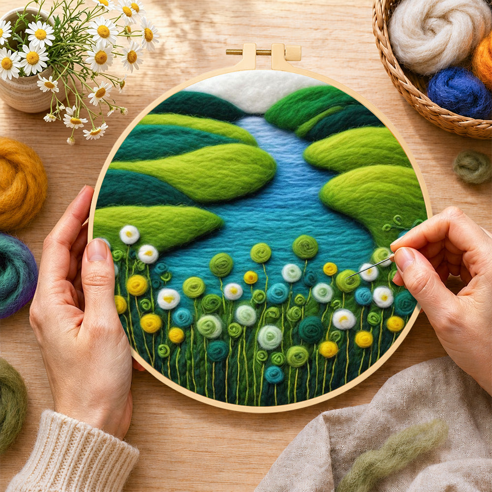 Creating the spring river and green flowers wool painting by hand with a felting needle