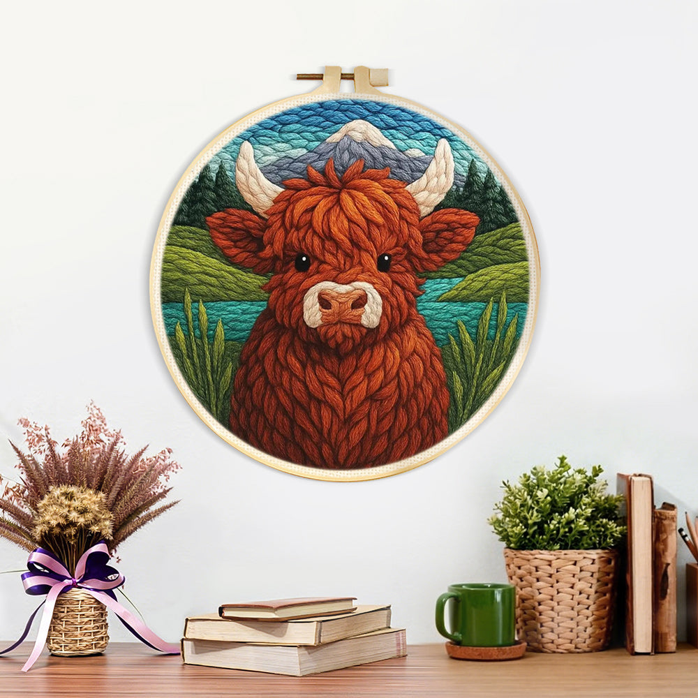 Finished springtime highland cow and mountain lake artwork displayed on a wall