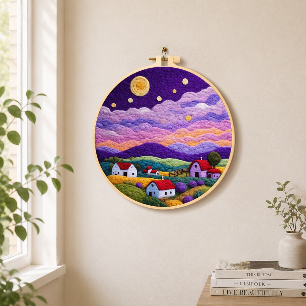 Starlit purple mountain village needle felt wall art displayed in a bright home interior