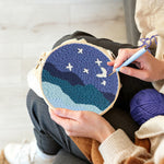Creating handmade starry night sky over mountains punch needle artwork