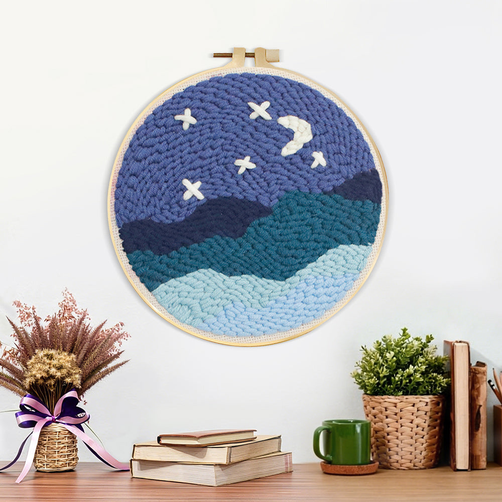 Finished starry night sky over mountains artwork displayed on a wall