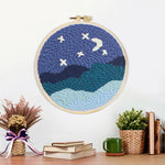 Finished starry night sky over mountains artwork displayed on a wall