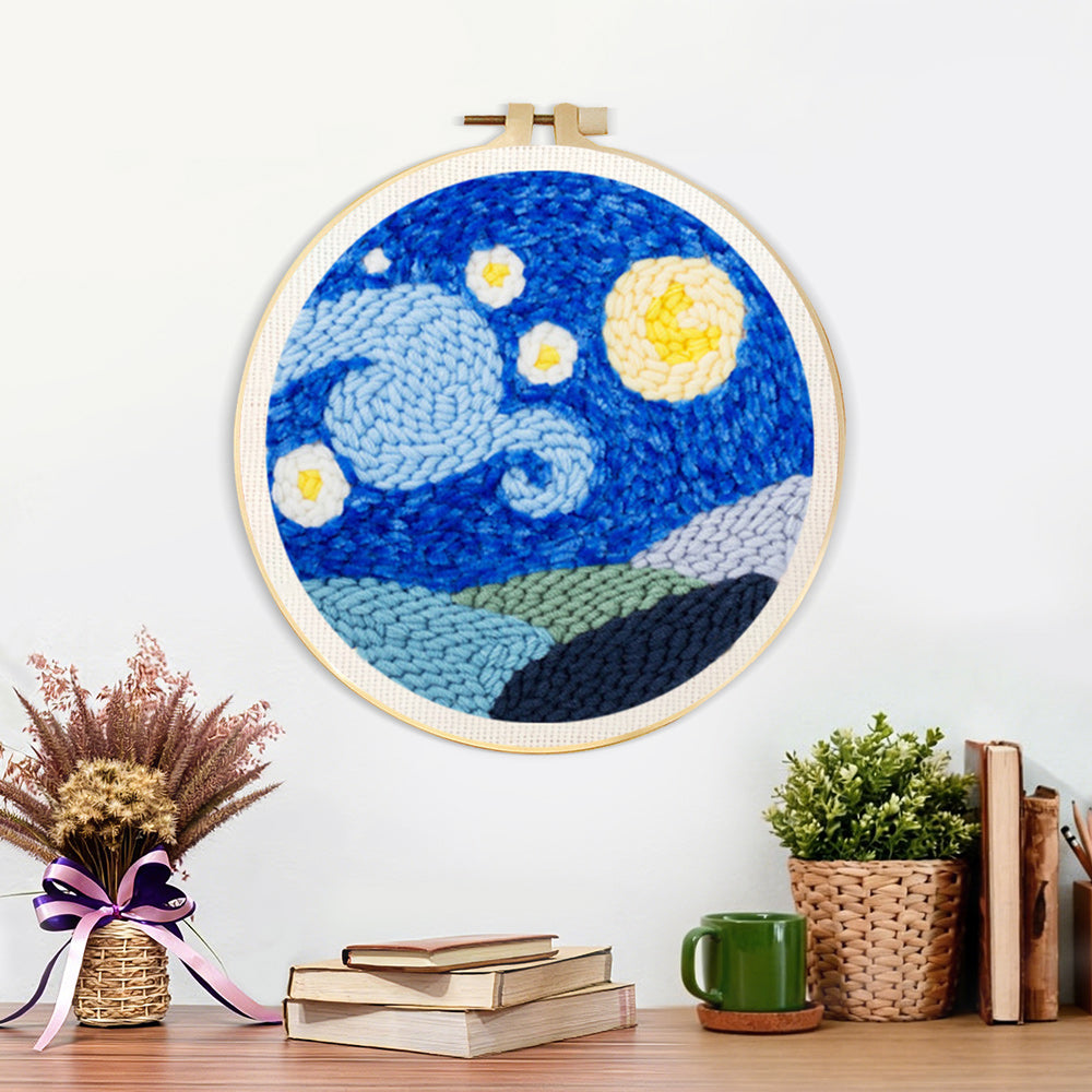 Finished starry night sky with moon and mountains artwork displayed on a wall