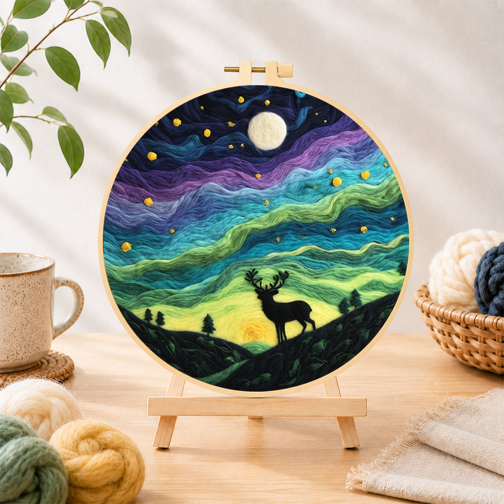 Finished starry night stag silhouette needle felting displayed on a wooden easel