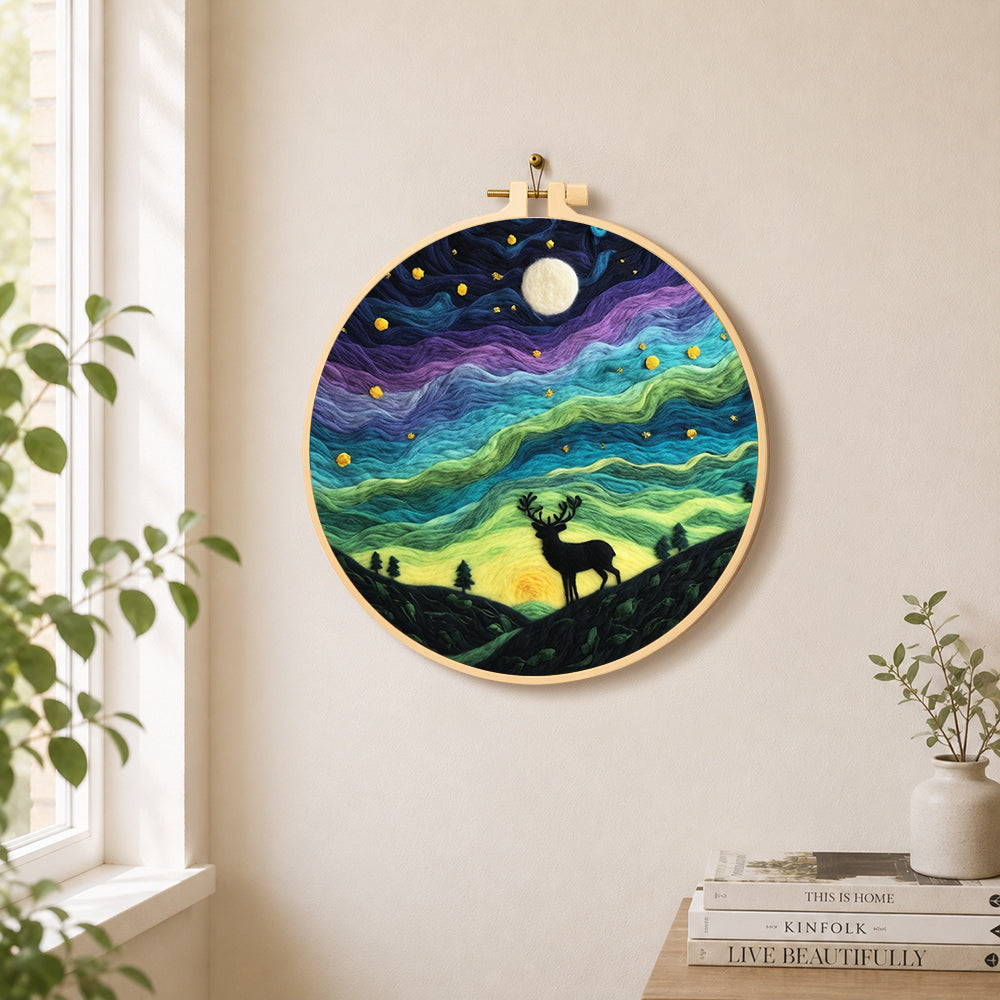 Starry night stag silhouette needle felt wall art displayed in a bright home interior
