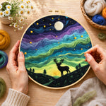 Creating the starry night stag silhouette wool painting by hand with a felting needle