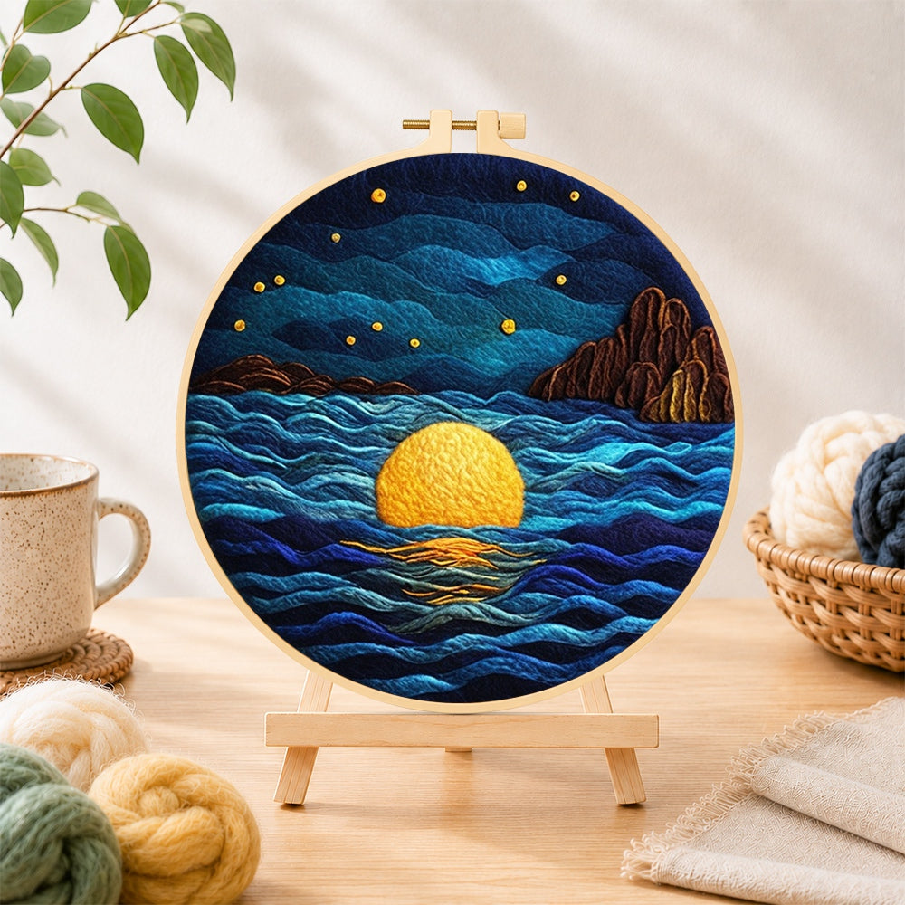 Finished starry ocean and golden full moon needle felting displayed on a wooden easel