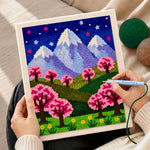 Creating handmade starry sakura mountain at night punch needle artwork